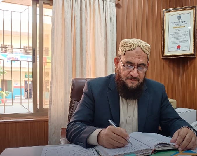 Chief Executive Director of JMT Public Higher Secondary School & College Karachi at his executive desk